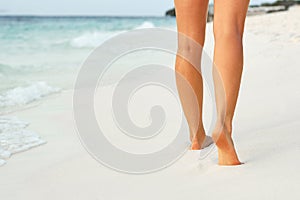 Ð¡lose up of woman leg on the beach. Woman  feet walking on the sand. Foot female