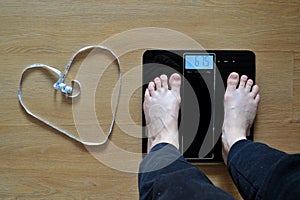 Lose weight concept with person on a scale measuring kilograms