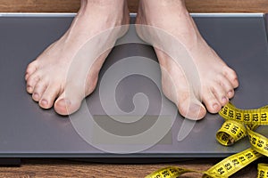 Lose weight concept with person on a scale measuring kilograms photo