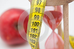 Lose Weight Concept with Red Apple and Tape Measure close up. Fat Burning and Weight loss process. Diet and Fitness