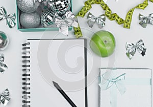 Lose weight for the new year, note pad. Christmas balls, sport shape, apple fruit, Diet concept. flat Lay. copy space