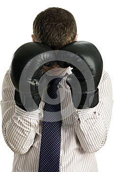 Loser businessman covers his face boxing gloves