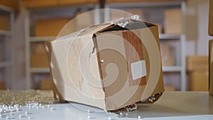 loses damaged cardboard parcel in the warehouse close up