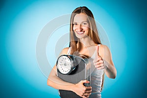 Losing weight - Young woman with measuring scale