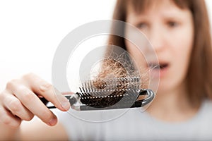 Loss hair comb in women hand
