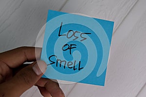 Loss of Smell write on sticky notes  on office desk