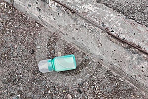 Lost baby bottle with milk lies on the side of the road