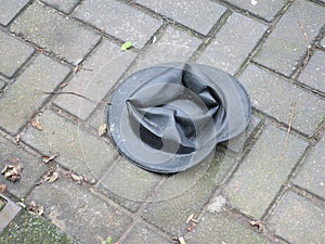 Lost black colored hat on the sidewalk