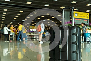 Lost black hardshell carry-on roller luggage left unattended at the baggage reclaim area at airport