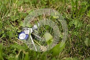 A lost bunch of keys and a key-ring lie in green grass on a spring day