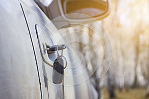 Lost car keys lying on the roadway, on a blurred background with bokeh effect