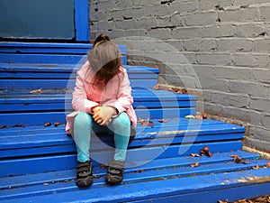 Lost child cries on steps photo