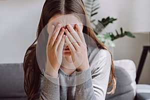 Lost in thoughts stressed brunette female regretting of wrong decision. Close up of unhappy anxiety young caucasian female