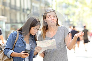 Lost tourists consulting map and phone