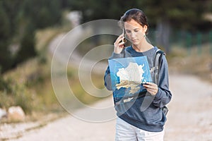 Lost traveler with map talking on smartphone