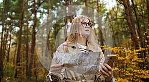 Lost traveler young woman searching direction in with a Topographic Map in the forest. High quality photo