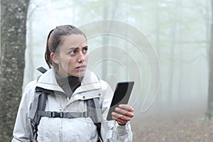Lost trekker using phone to locate in a forest
