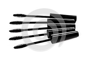 A lot of black Mascara wands on white background