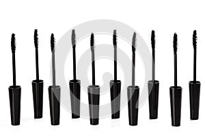 A lot of black Mascara wands on white background