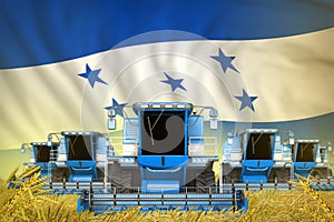 A lot of blue farming combine harvesters on rural field with Honduras flag background - front view, stop starving concept -