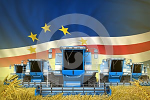 A lot of blue farming combine harvesters on rye field with Cabo Verde flag background - front view, stop starving concept -