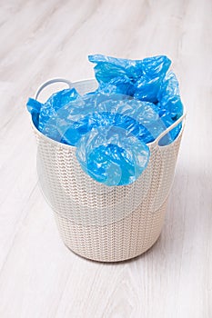 a lot of blue shoe covers in the basket, new or used shoe covers