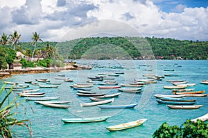 A lot of boats moored on standing and blue ocean