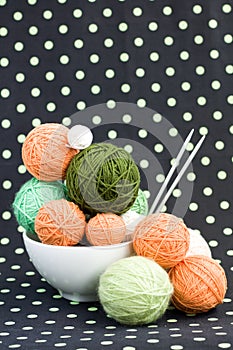 A lot of bright balls for knitting on a background