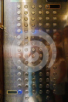 A lot of buttons in the elevator of a skyscraper.