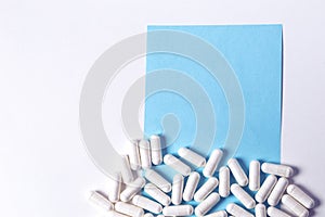 A lot of capsules pills on white background with copy space on t