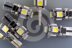 Lot of Car light bulbs emitting diode, accessories and components for electronics vehicles. Gray background close-up. 12V T10