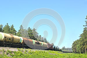 A lot of cisterns freight train on the run in summer, transportation of combustible lubricants