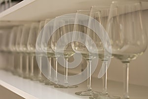 Lot clear wine glasses on high leg in row on rack sell in the store