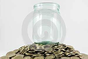 A lot of coins and a glass jar