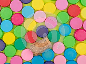 Lot of colorful plastic lids and a wooden tube