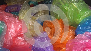 A lot of Colorful Single-use Plastic Shopping Bags throw away form a big pile. Plastic Packaging Pollution. Plastic