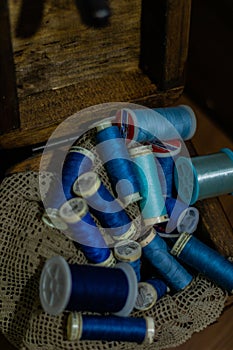 Lot of colorful yarn rolls in a woven basket in a tailor's studio