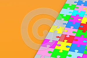 Lot of connected colorful puzzle jiggle pieces on orange background. Copy space