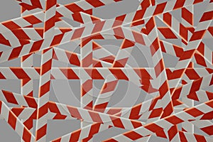 lot of crossed red and white ribbons isolated on a gray background. These tapes are used as a sign to mark and prevent