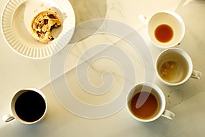 Lot of cups of coffees on white marble table, hard work concept