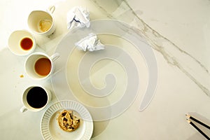 Lot of cups of coffees on white marble table, hard work concept