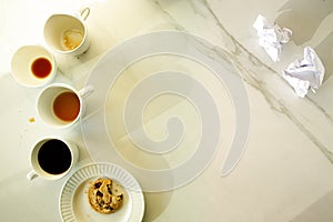 Lot of cups of coffees on white marble table, hard work concept