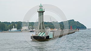 Lot of curious birds sitting around lighthouse escorting sailors to safe voyage