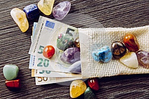 Lot of different color and type semi precious stones with euro money bank notes.