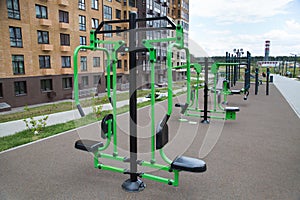 A lot of different fitness equipment made of metal on the Playground in the city outdoors. Sport is a healthy lifestyle