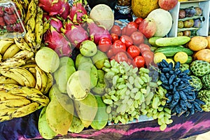 A lot different fresh tropical fruits on the counter. Fruit market