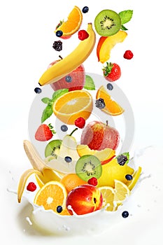 Lot of different fruits falling into milk