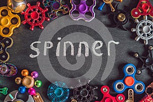 A lot of different spinners on a black background And the inscription spinner