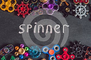 A lot of different spinners on a black background And the inscription spinner