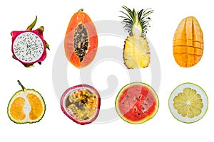 A lot of different tropical fruits cut halves isolated on white